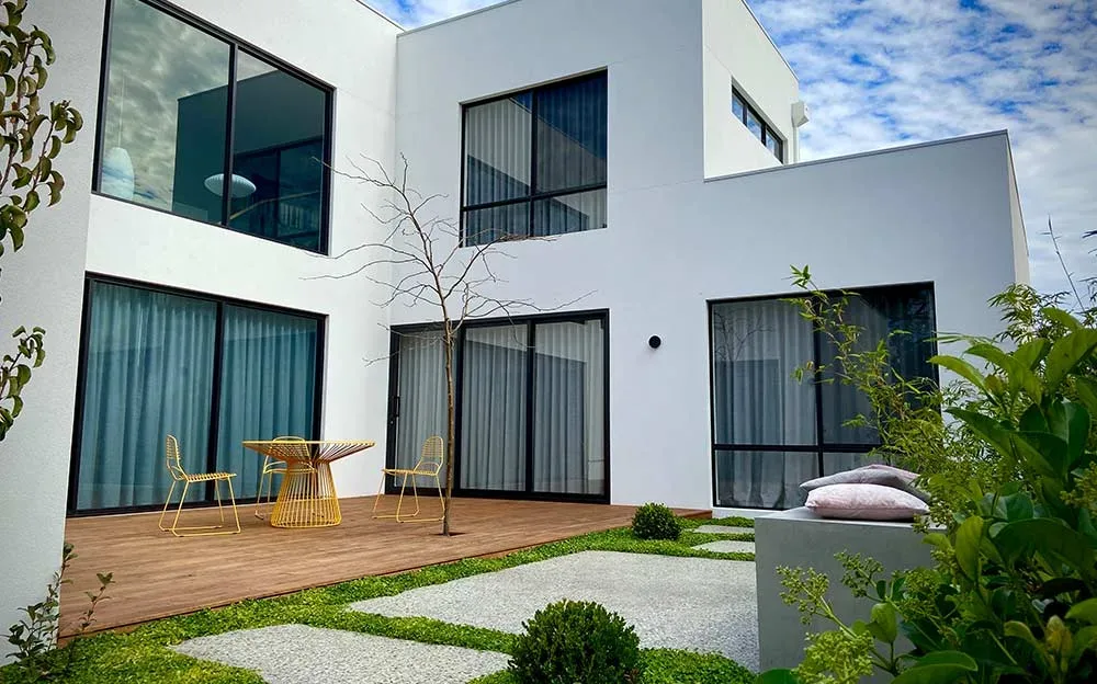 Timber deck with outdoor dining table beside glass sliding doors